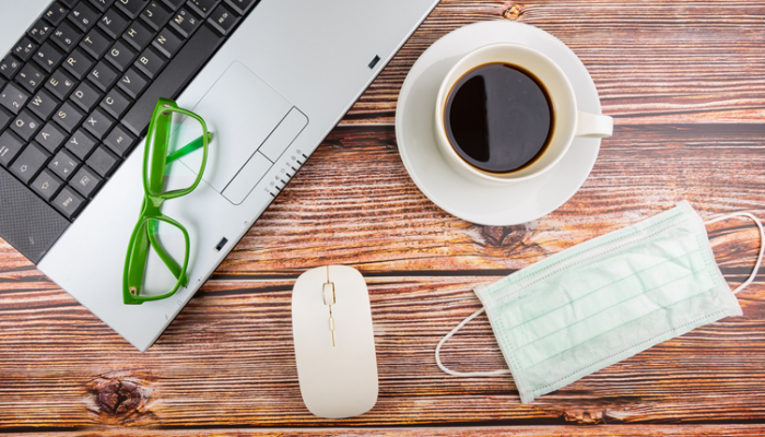 Laptop, glasses, coffee mug, mouse and face mask